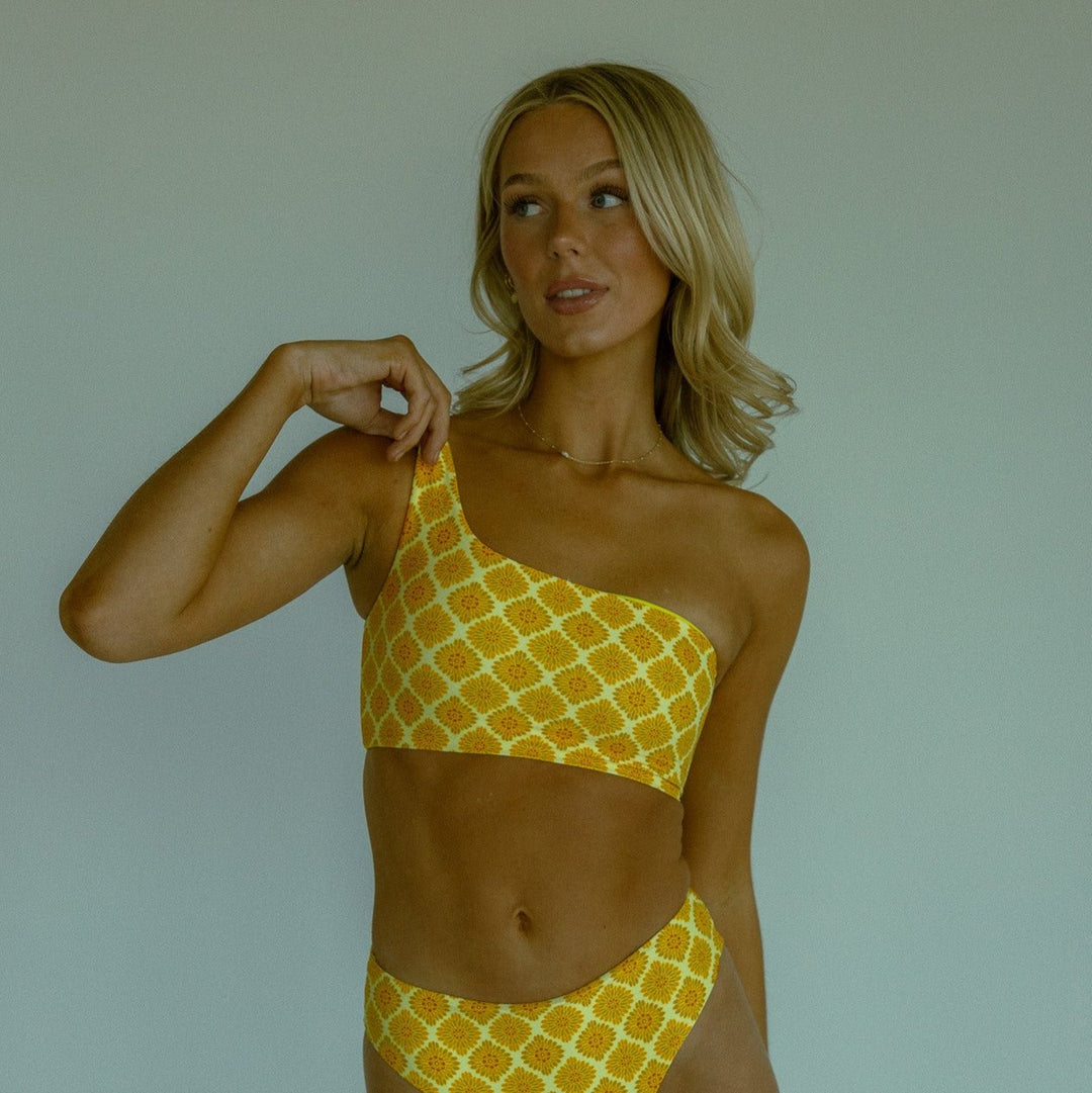 Yellow patterned seamless bikini top with one shoulder design.